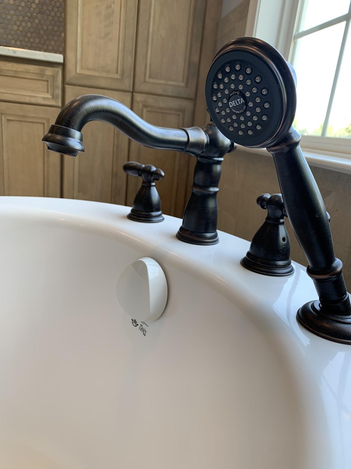 Freestanding tub faucet with hand shower, bronze finish
