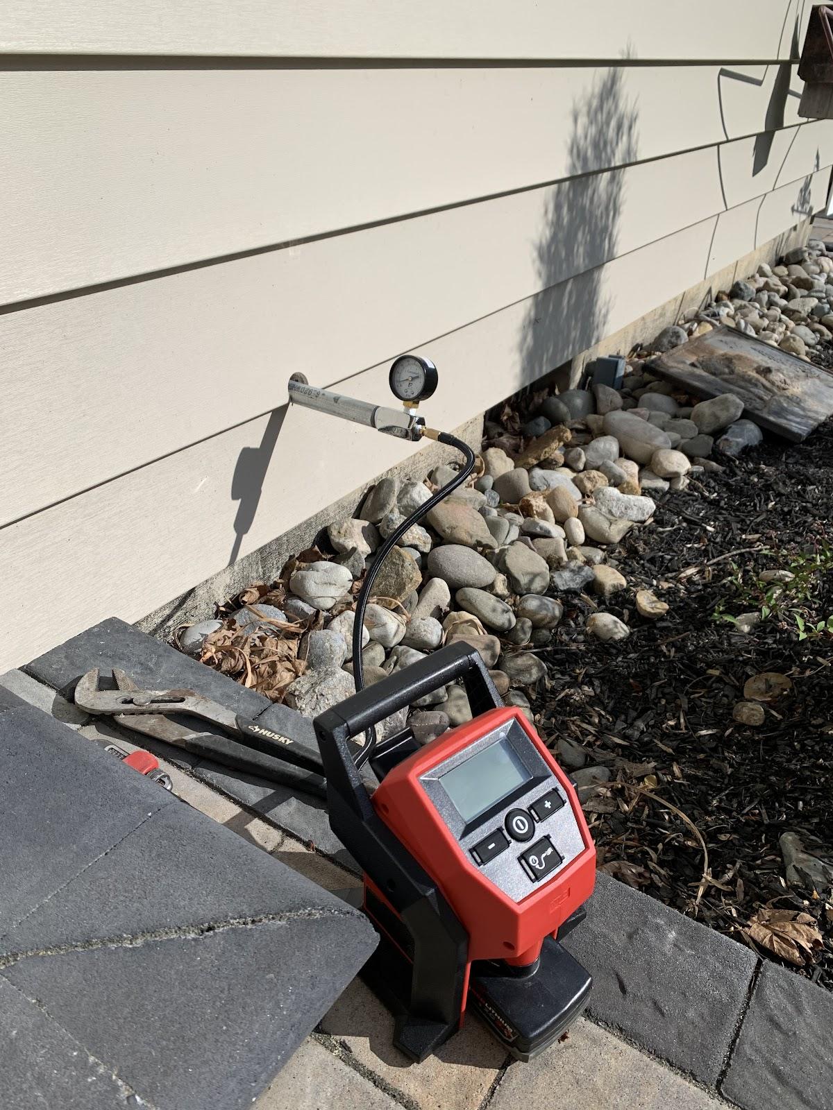 Gas line pressure test running at an exterior wall